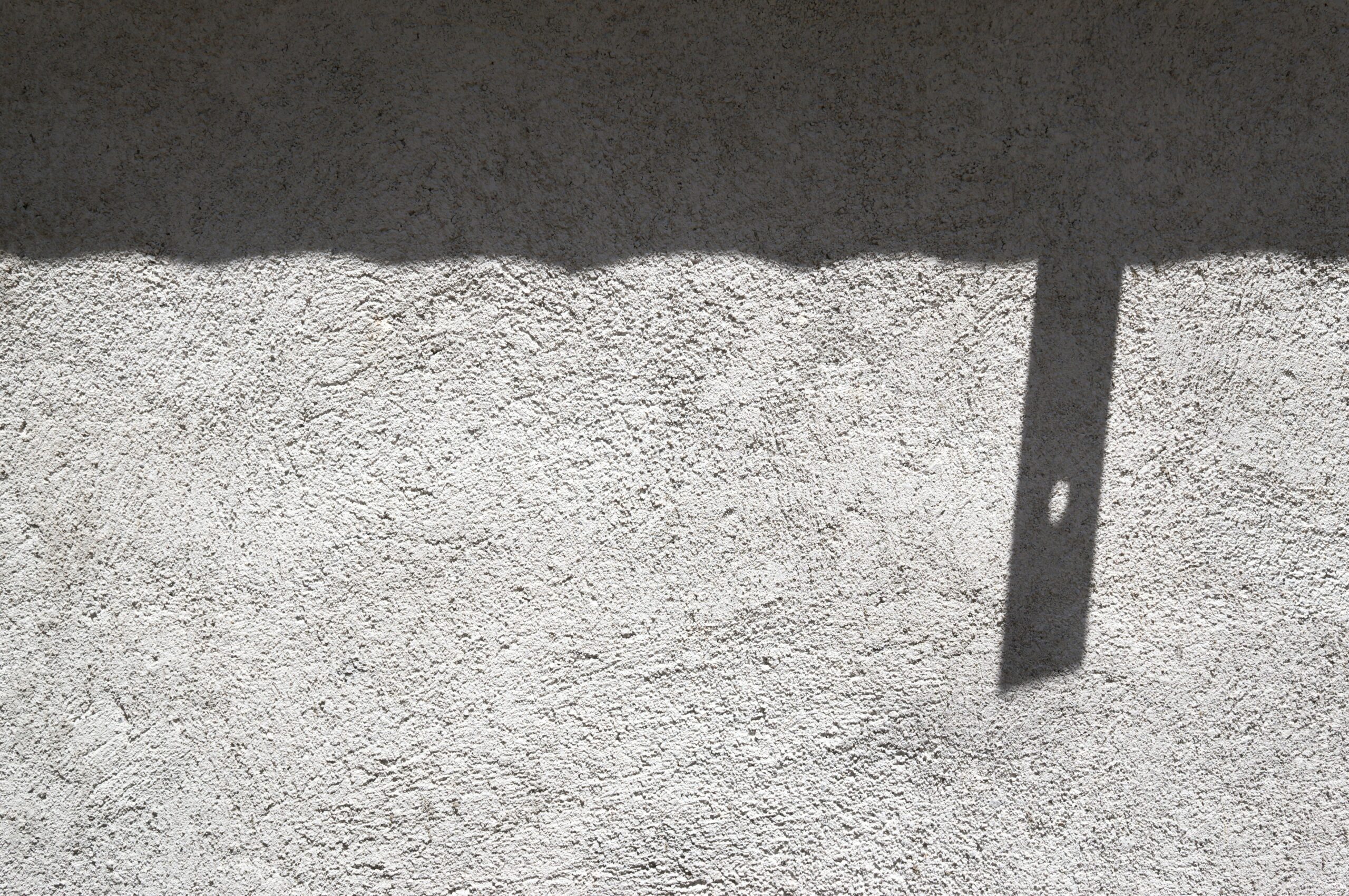 a shadow of a clock on a wall