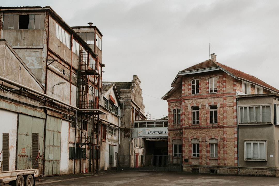 Old and weathered buildings stand under a cloudy sky.