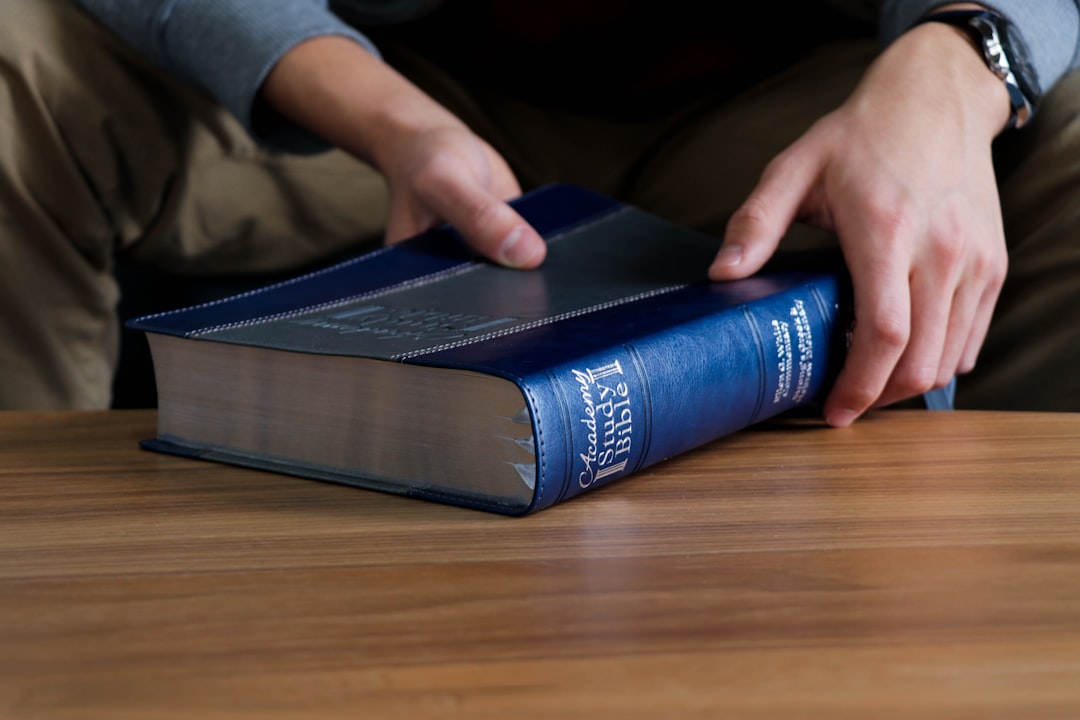 person holding Holy bible