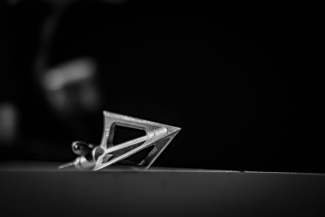 silver key on black and white surface