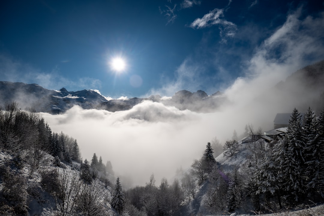 A snow covered mountain with a full moon in the sky